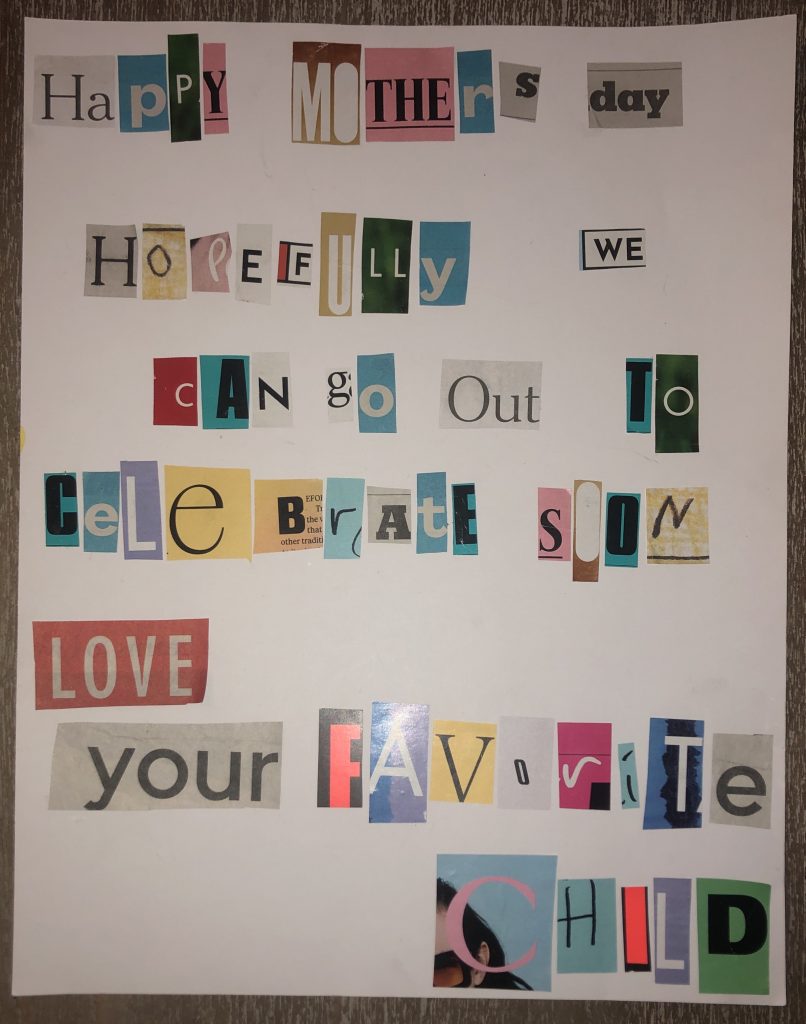 The word LOVE on a bulletin board using cut-out paper letters in