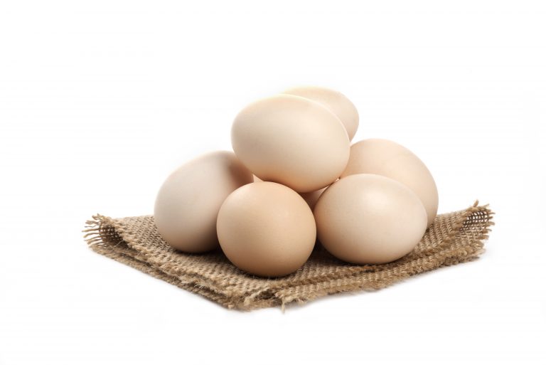 Three fresh organic raw eggs isolated on white surface. High quality photo