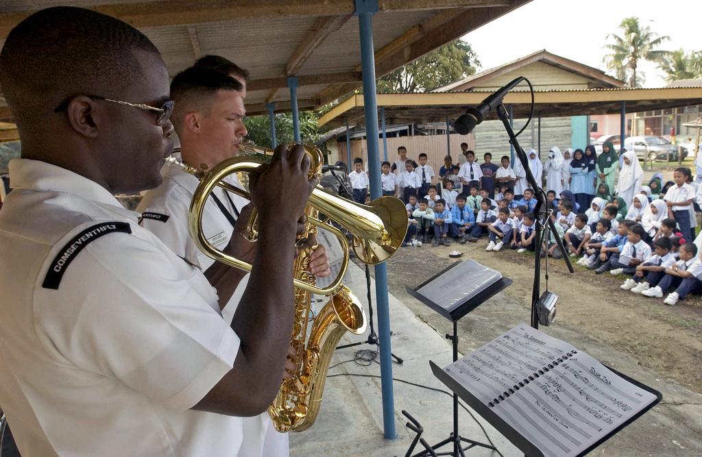 060726-N-9851B-003 (Jul. 26, 2006)  
US Navy (USN) Musician Third Class (MU3) Antonio Rice, 7th Fleet Band, plays a flugelhorn as Musician First Class MU1) Gresh Laing, plays a saxophone for students of the elementary school outside the city of Kemaman, Malaysia (MYS), during Exercise Cooperation Afloat Readiness and Training (CARAT).
U.S. Navy official photo by Mass Communication Specialist Second Class John L. Beeman (Released)
