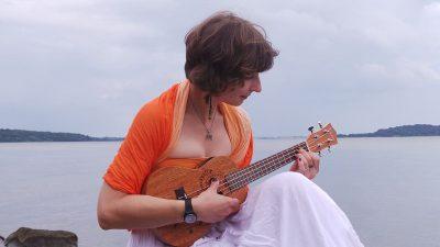 Ukelele being played by woman