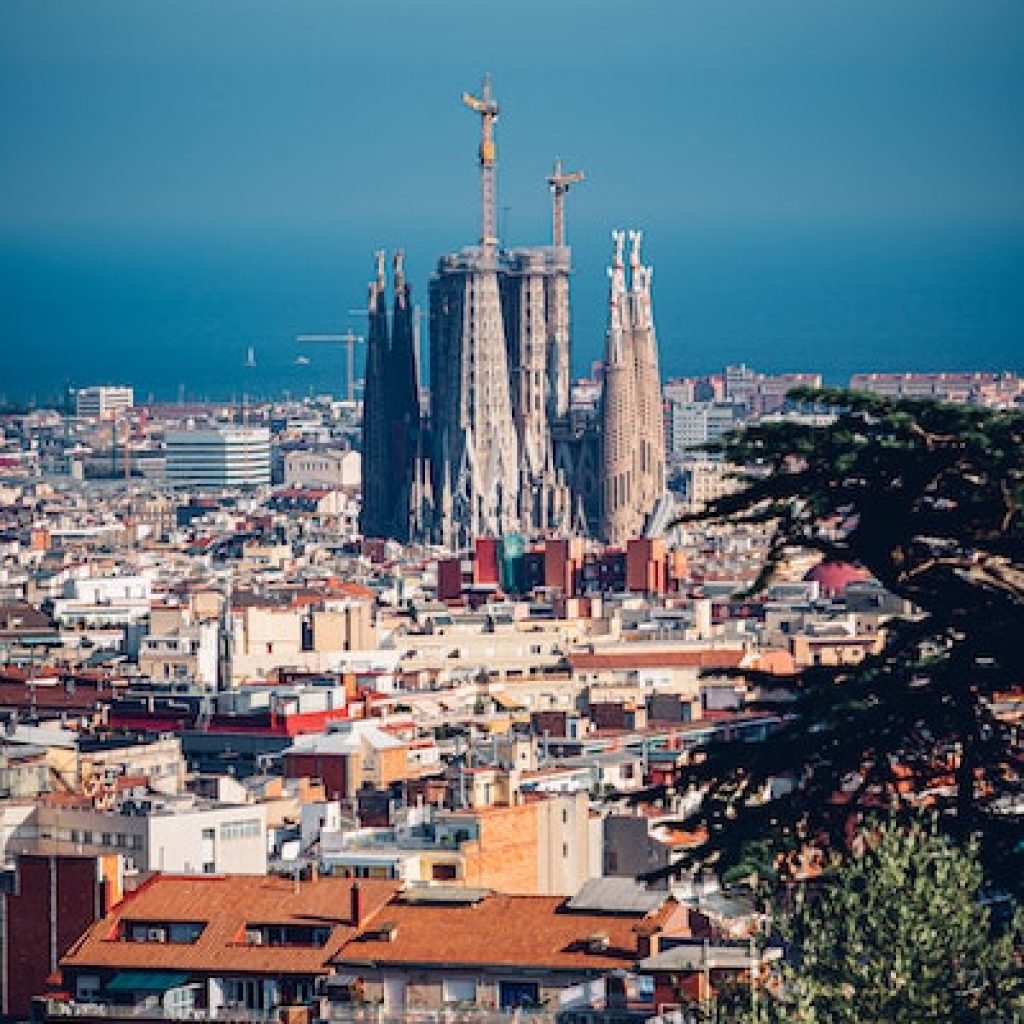 distant view of La Sagrada Familia church being built in spain among all small building around it