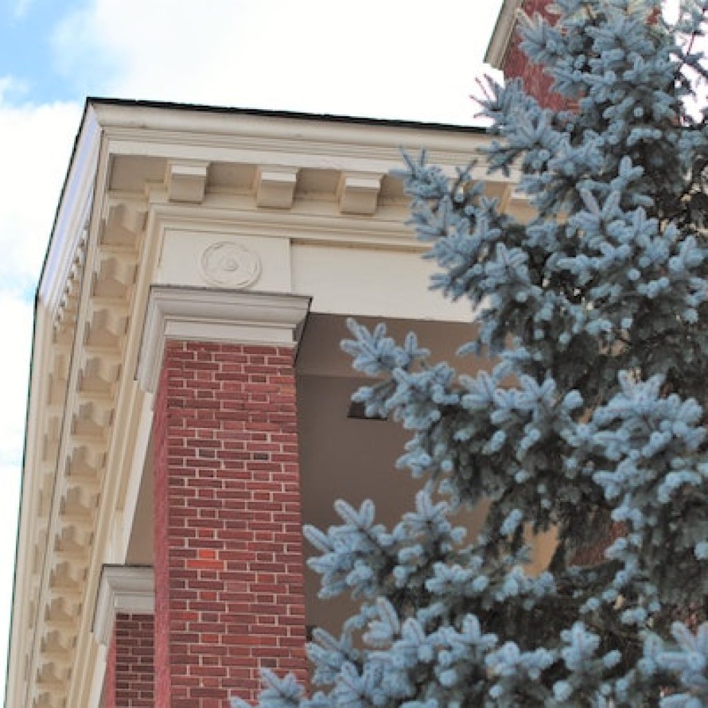 Corner of the facade of a building with moldings.