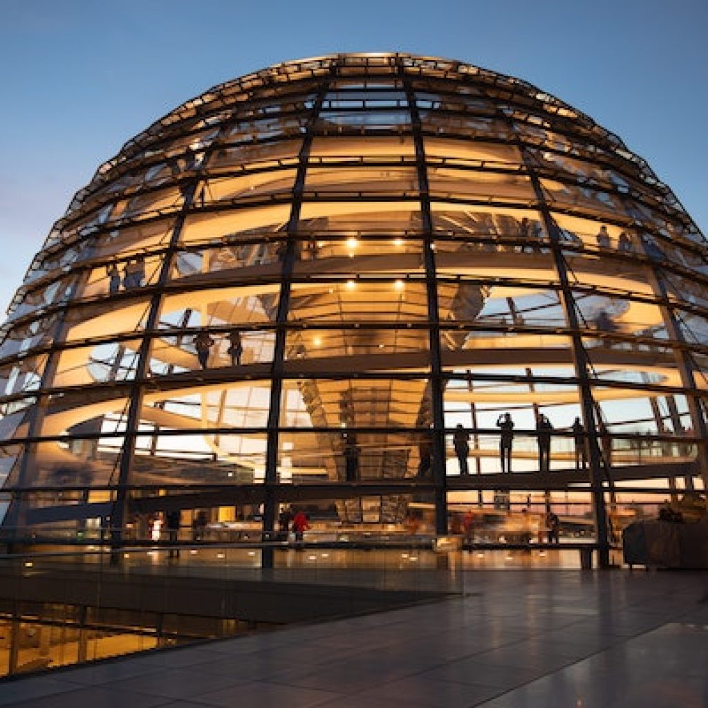 Large dome lit up with yellow lights during a sunset.