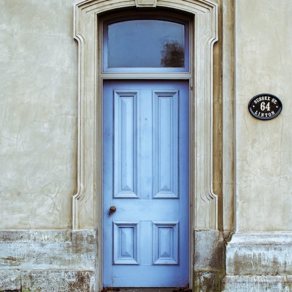 Light blue colored front door with molding all around.