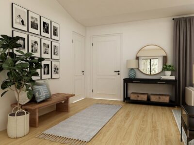 Entryway of a home with a bench and entry table with a hanging mirror.