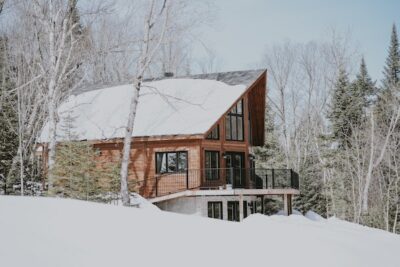 Wooden cabin in the woods during winter.