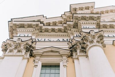 View of the molding of the exterior of a building covered in black and gold detailing.