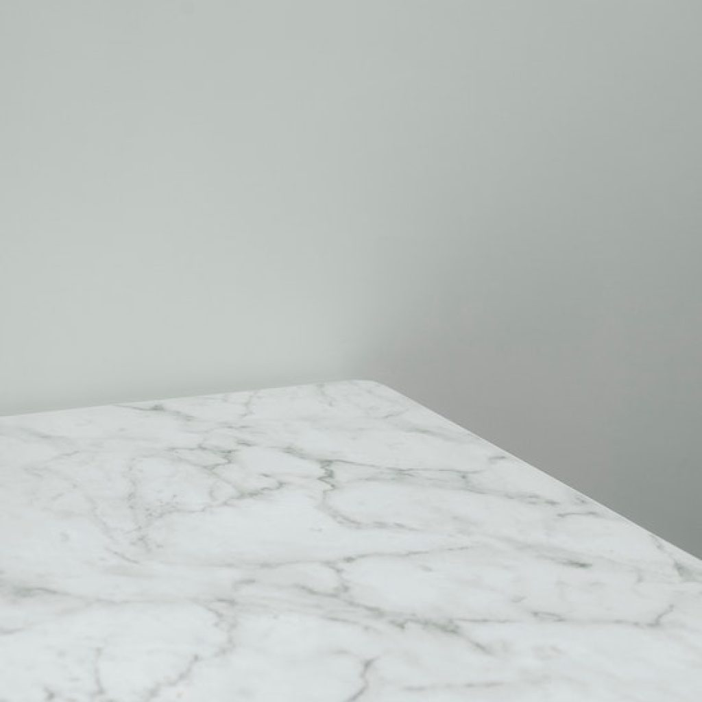White marble with gray veins against a gray-white wall