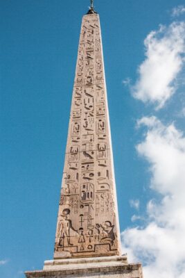 Tall stone obalisk with ancient writing from the bottom to the top