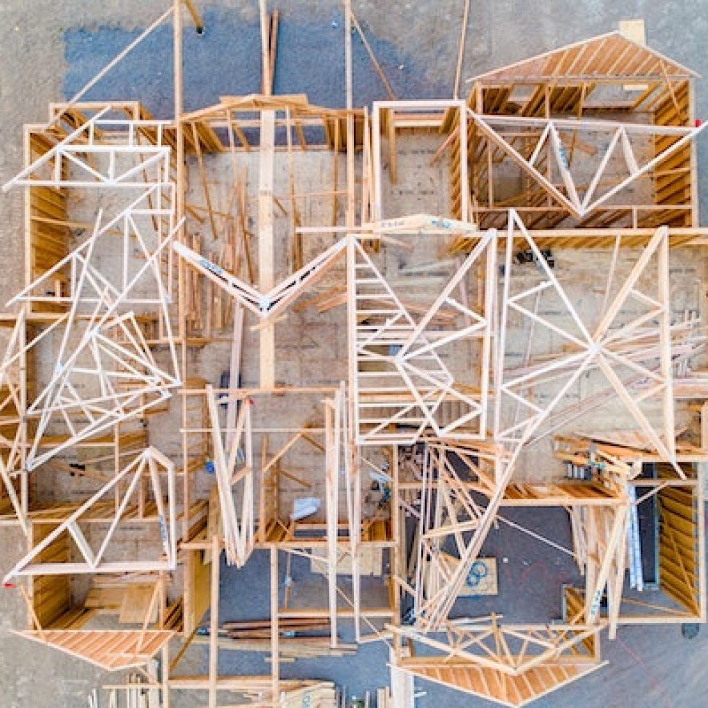 Aerial view of the wooden structure of a home being built