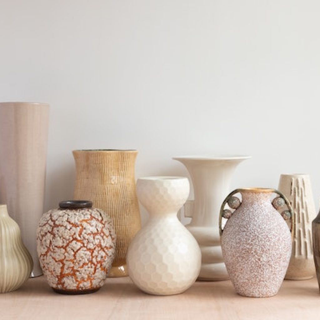 Different size, shaped, and colored urns with a white background
