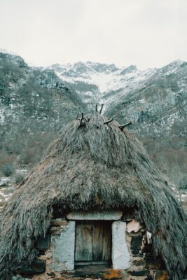 Tent like structure with a door in the middle of the mountains