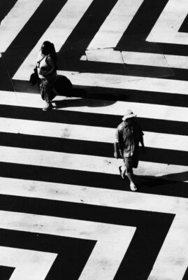 black and white zigzag patterned walkway with two people walking on it